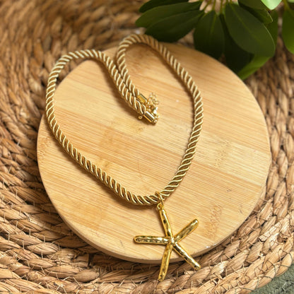 Gold necklace on a wooden coaster with a natural background