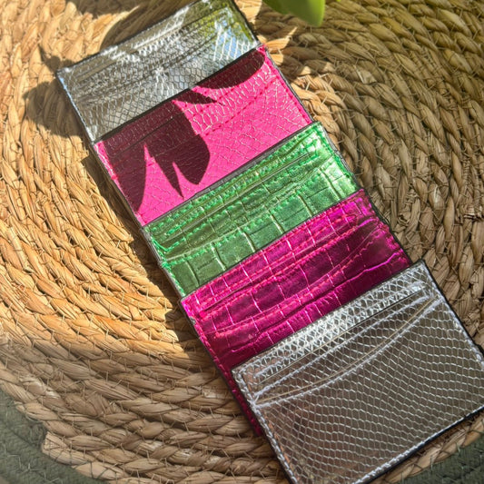 Colorful wallet with crocodile texture on a woven surface